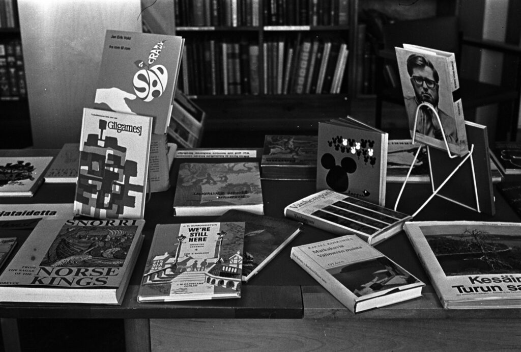 Svartvit bild på böcker som ligger på ett bord.